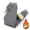 Grey fleece-lined men's oversized track pants with elastic waistband laid flat.