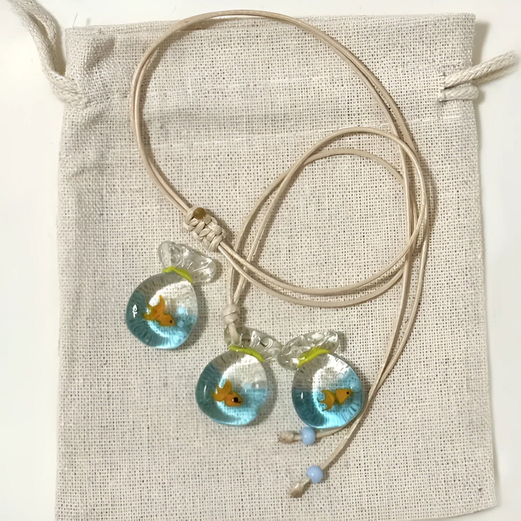 Women's necklace with Small Fish Lucky Bag glaze pendant on a cotton linen chain.