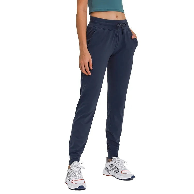 Women's high-waist yoga pants with drawstring waistband in a cotton blend fabric.