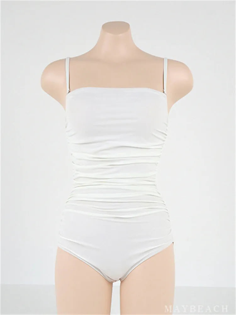 Women's sling style one-piece swimsuit with belly pleats in solid colour options