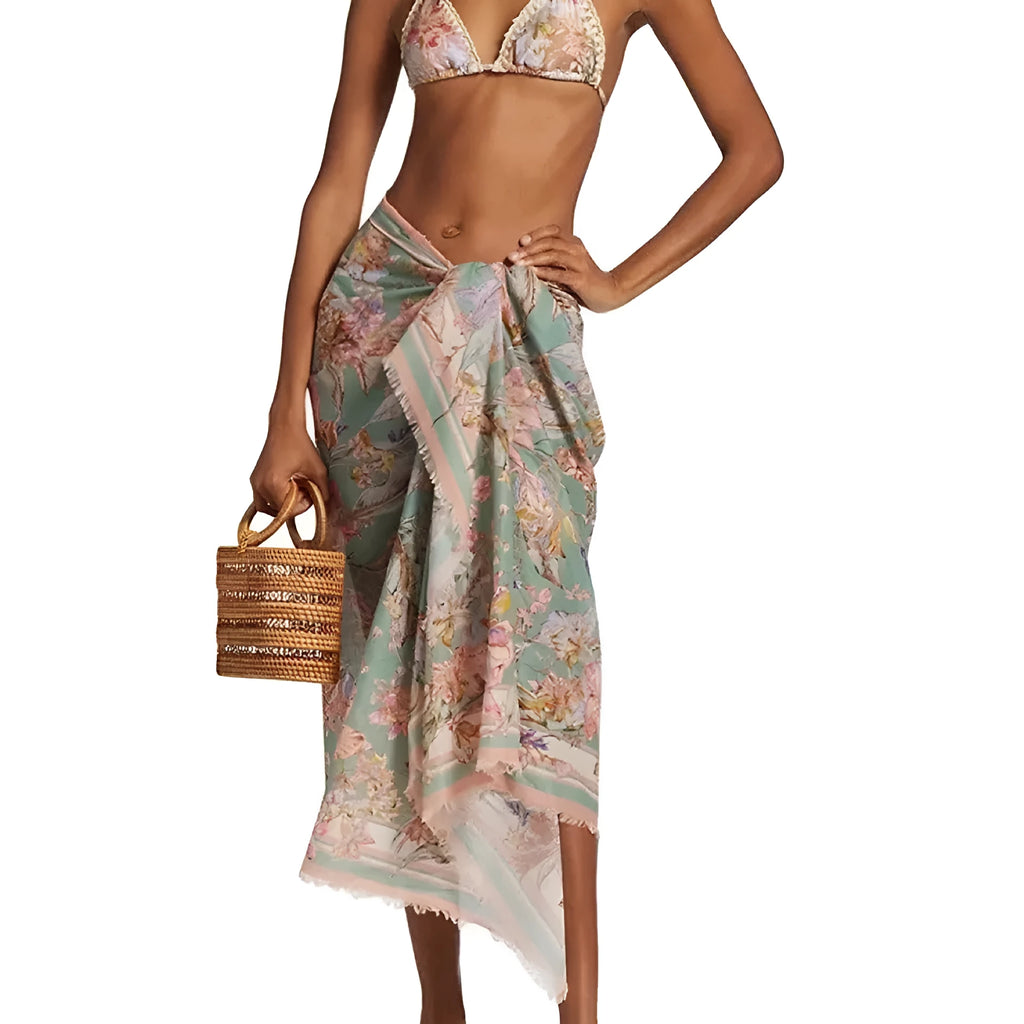 Women's creamy white floral bikini set with skirt cover-up on beach