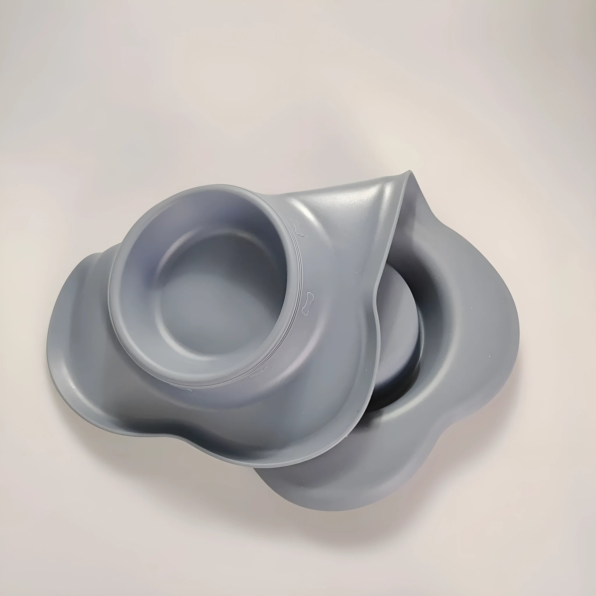 Large black silicone dog bowl seated inside a weighted stainless steel base