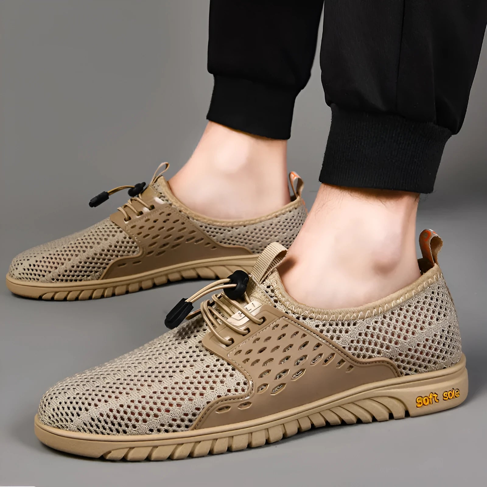 Men's black breathable mesh casual shoes with elastic band and rubber sole.