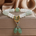 Green crystal abacus bead bracelet with retro butterfly tassel and pearl accents on a 17cm chain.