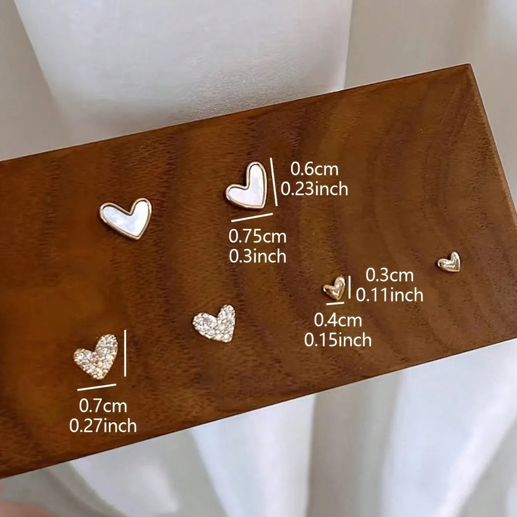 Three pairs of heart shape alloy earrings with electroplated gold, black, pink, and black-white colour options