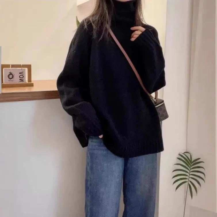 Women's loose-fit turtleneck sweater with a thick, textured curling pile collar in a grey solid colour.