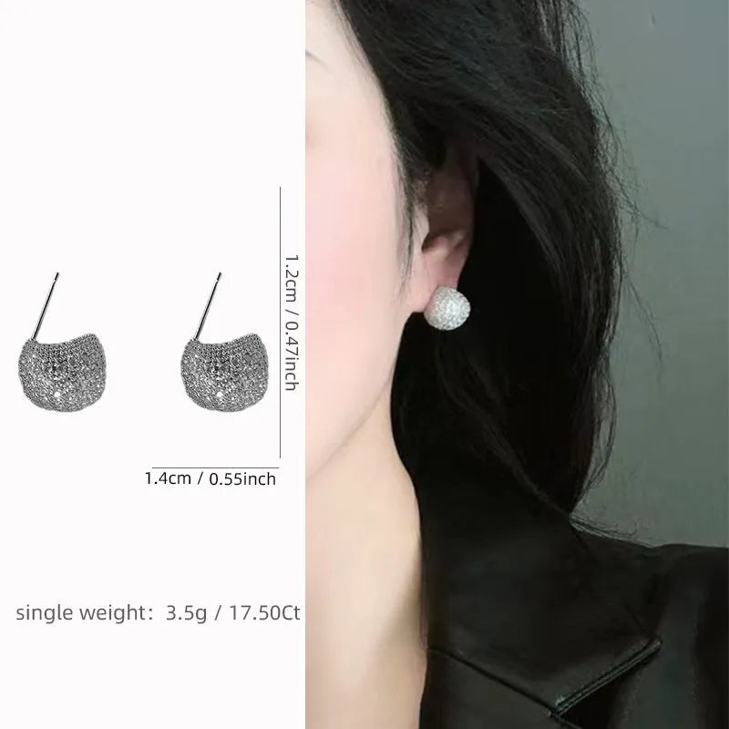 Geometric drop-shaped clip earrings with sphere elements and diamond flashing in gold or white colour