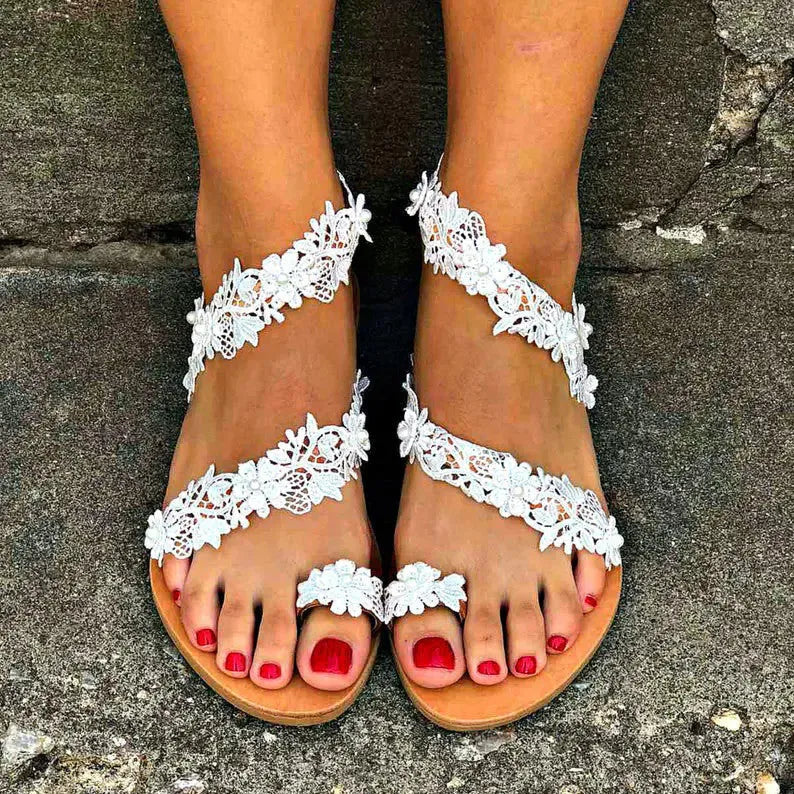 White plus size women's flat shoes with rhinestone and flower decoration on the upper.