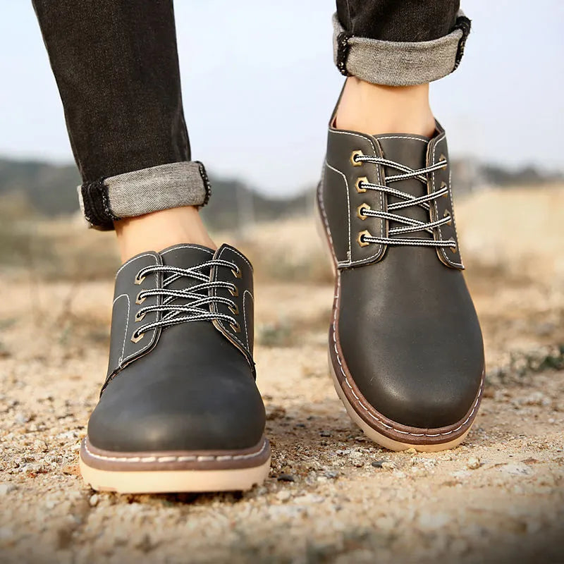 Men's black mid-top leather-style boots with rubber sole
