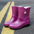 Women's middle tube rain boots in purple, black, and beige colours with non-slip soles