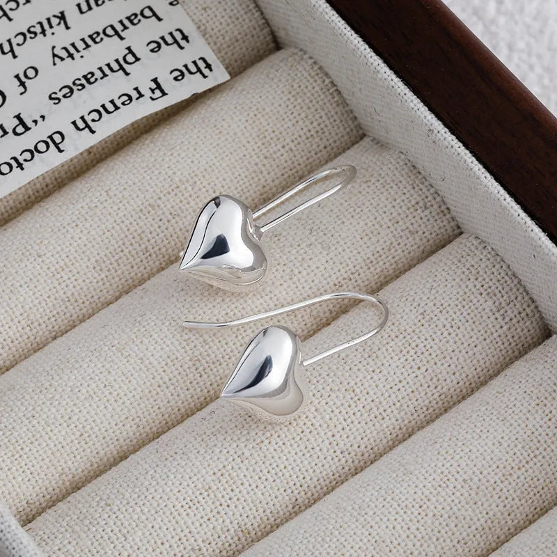 Silver heart-shaped earrings with three-dimensional glossy finish and Korean style design