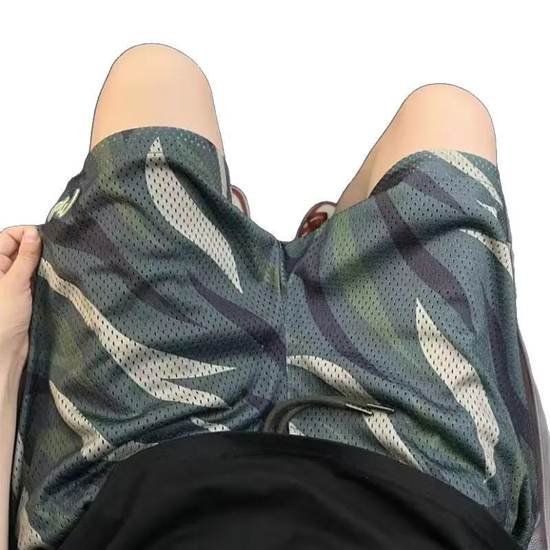 Men's straight-cut camouflage mesh shorts in cotton blend fabric on a hanger.