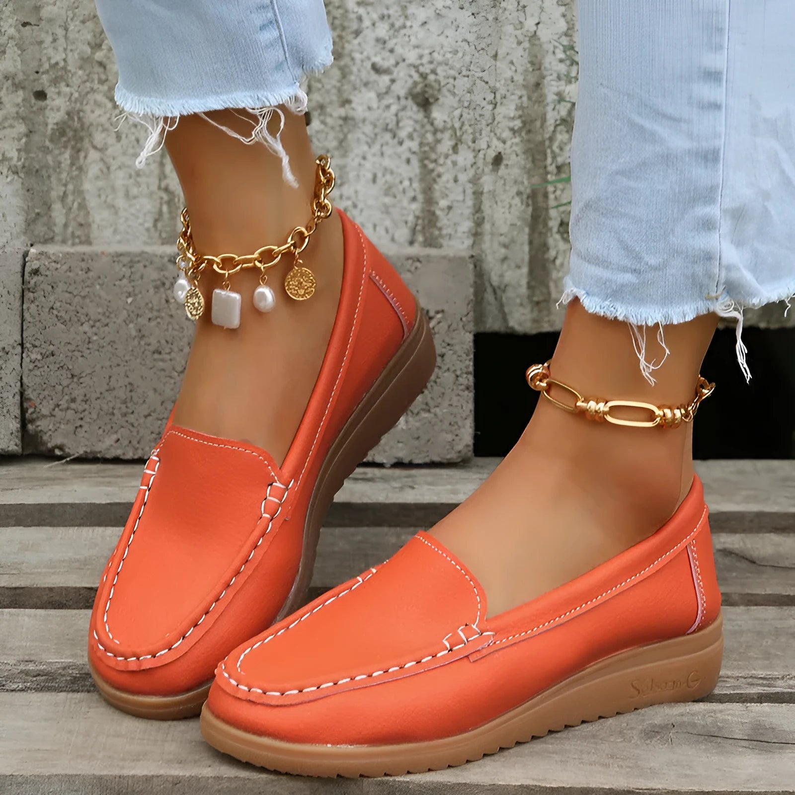 Women's PU leather slip-on loafers in round toe flat heel design showing car suture detailing
