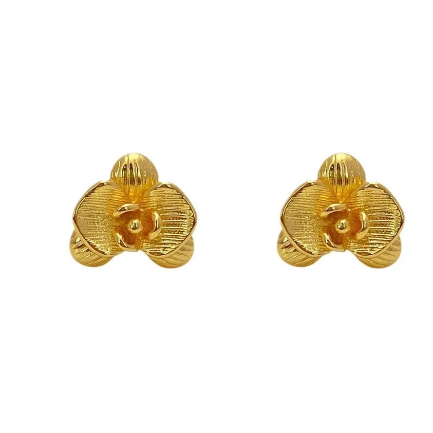Retro flower earrings in gold or silver with detailed petal design on copper base