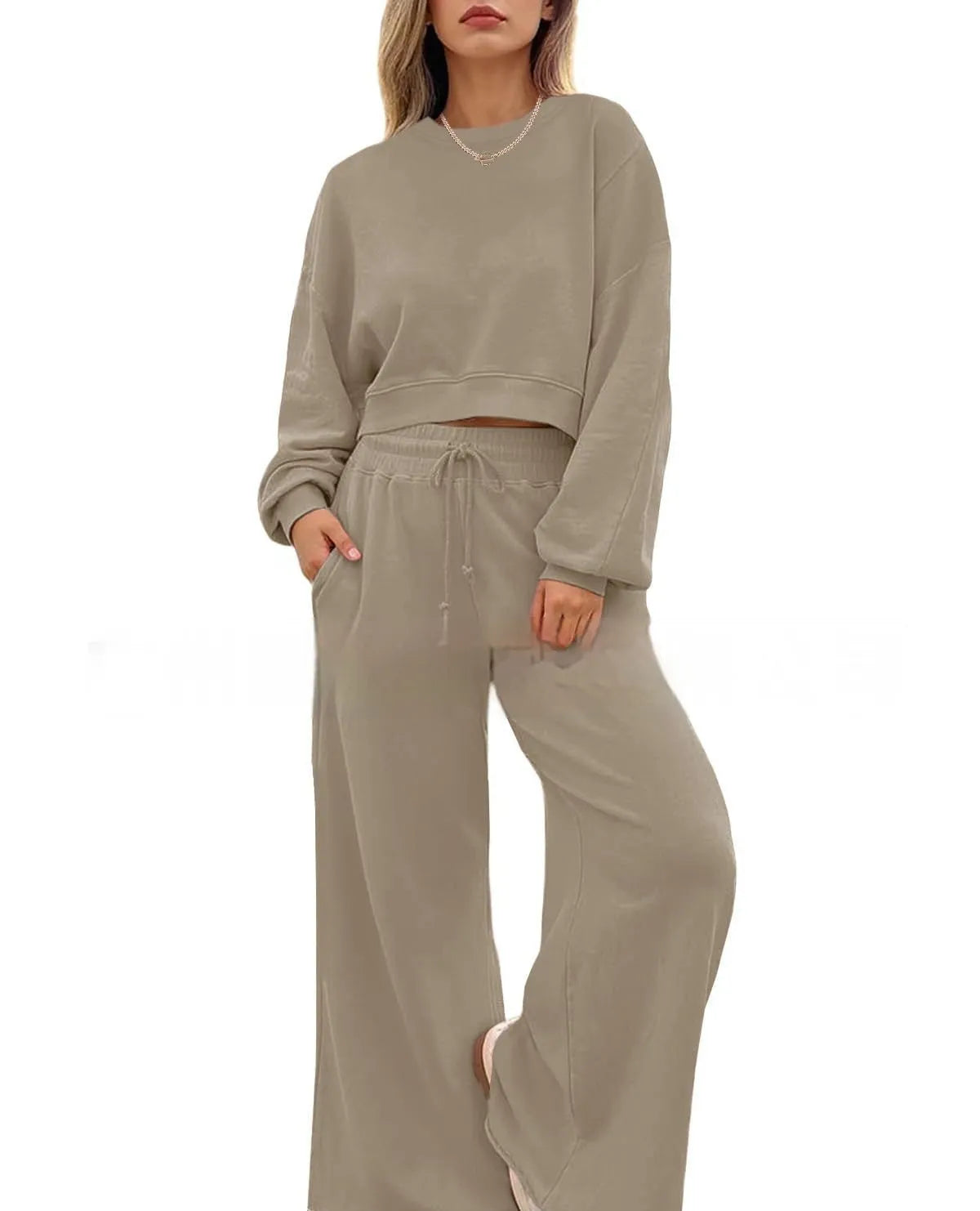 Women's solid colour long sleeve top and trousers two-piece set in polyester fabric.