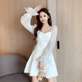 White women's long sleeve maxi dress with patchwork detail and a fitted waist.