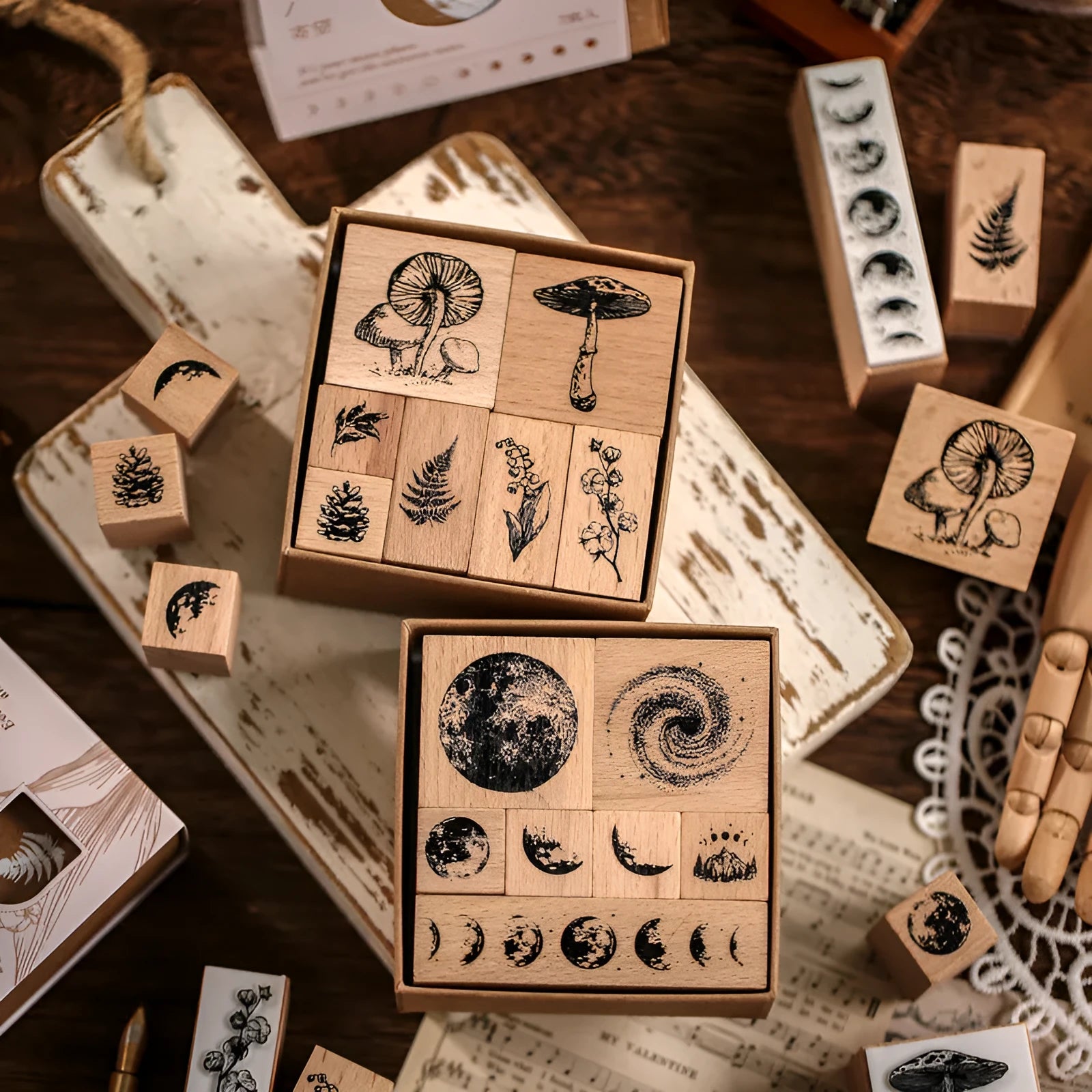 Set of seven wooden craft stamps for DIY journal decoration in stars and moon or plant catalog designs.