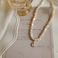 French court vintage style necklace with geometric alloy pendant and pearls on an adjustable chain.