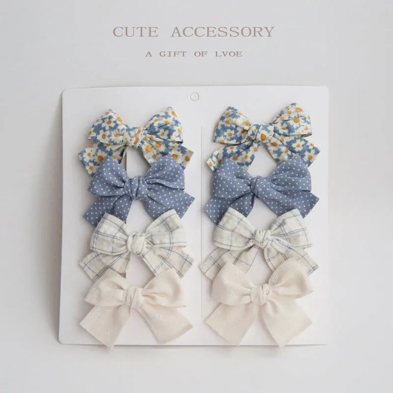 Children's fabric dovetail bow hair clips in eight pattern options