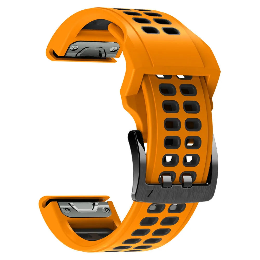 Close-up of a two-tone black and orange silicone watch strap with quick-release pins and a pin buckle.