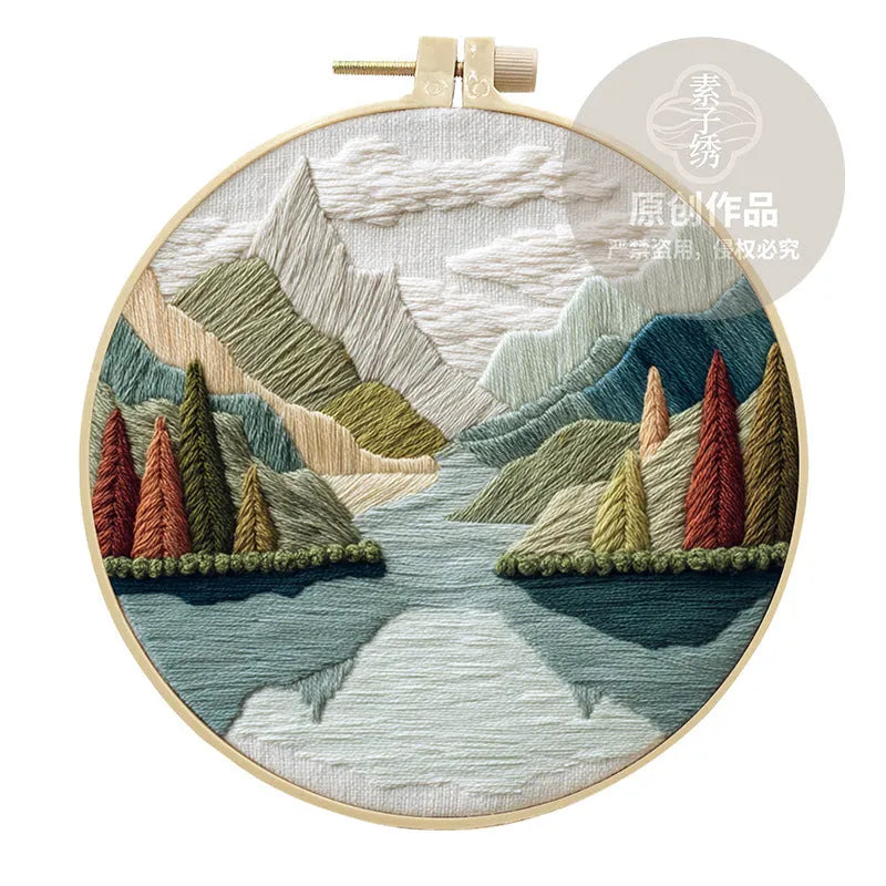 Embroidery kit with cotton fabric, bamboo frame, threads, and printed landscape design for DIY textile art