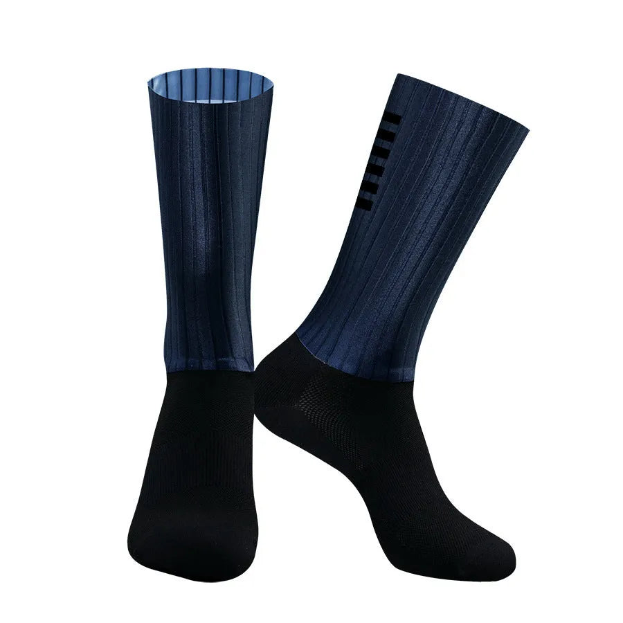 Pair of breathable athletic socks for running and cycling in orange colour on a grey background
