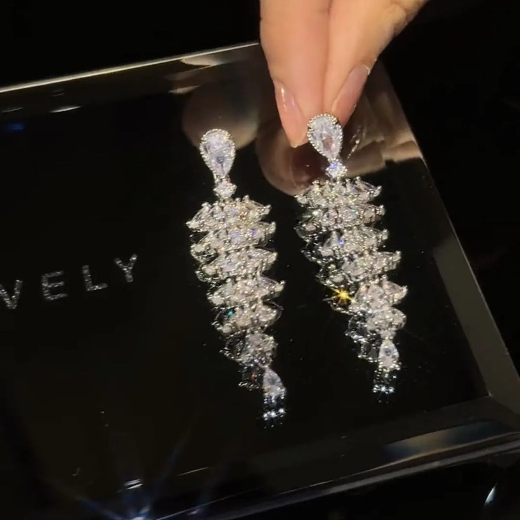 Silver pagoda Christmas tree drop earrings with sparkling zircon crystals on copper studs.