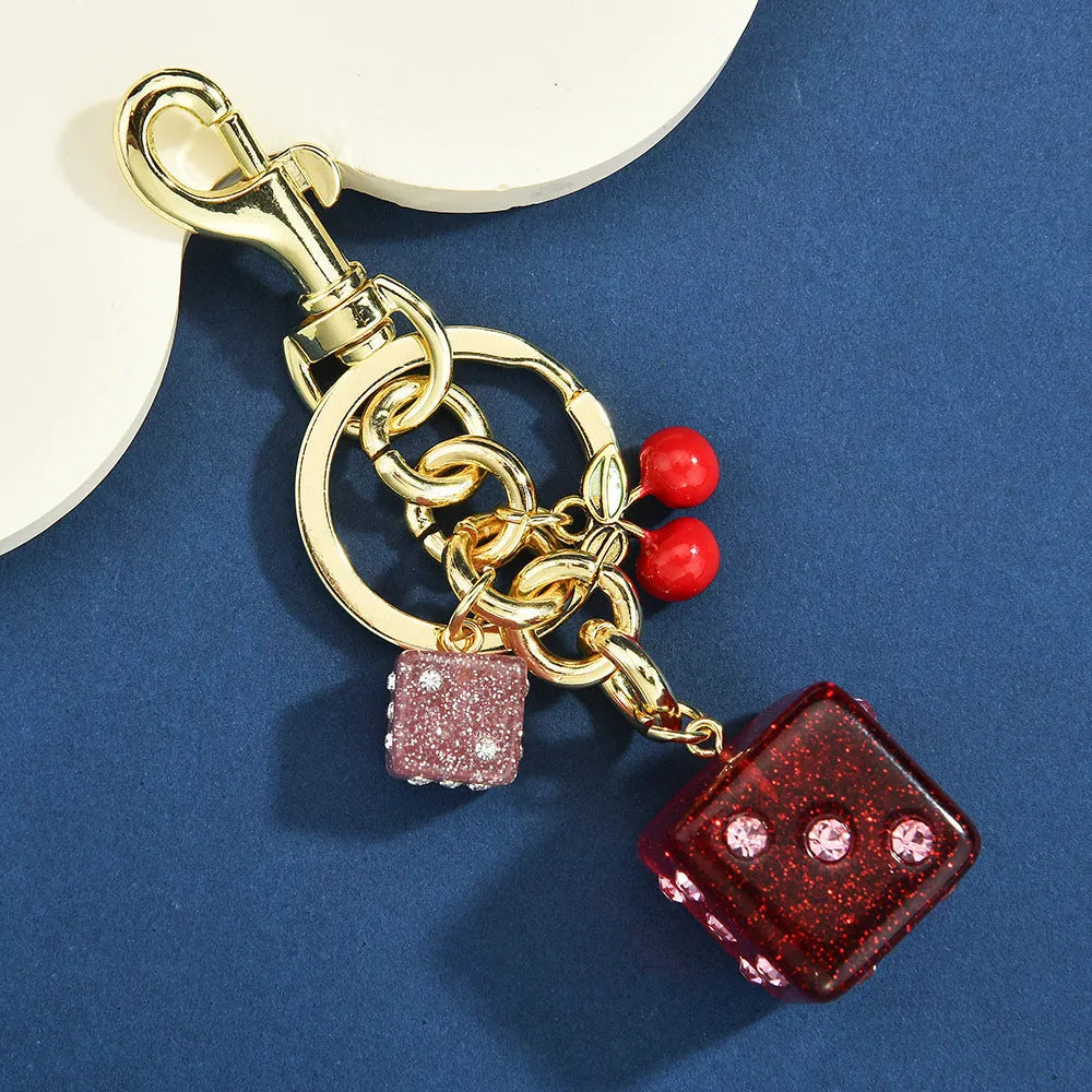 Cherry two-tone dice keychain pendant with square pattern metal design