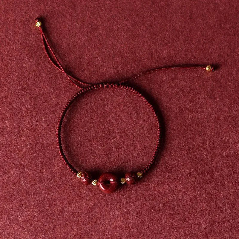 Cinnabar safety buckle bracelet with heart-shaped pendant on adjustable rope cord