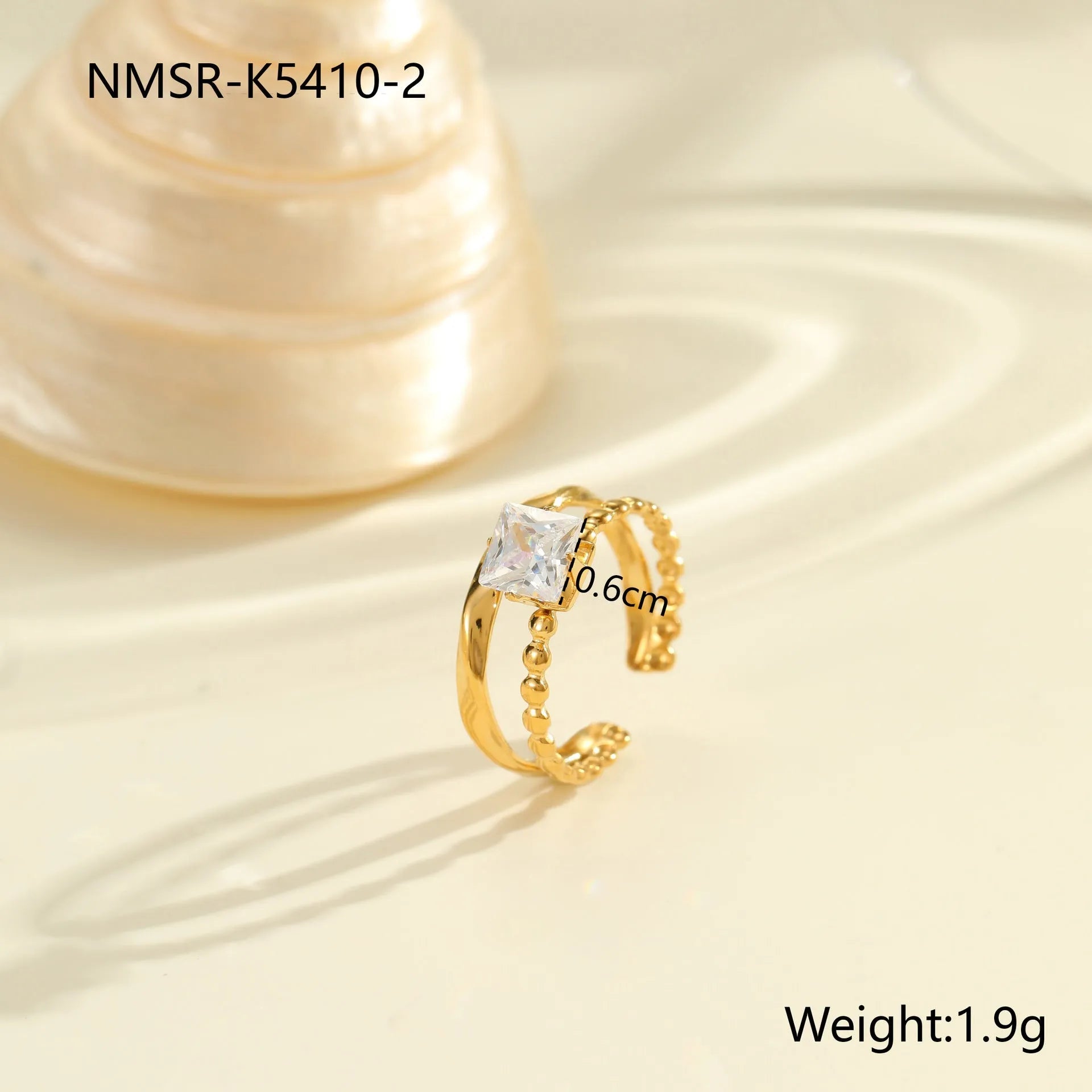 Gold-coloured stainless steel open ring with zircon stones in a geometric heart design.