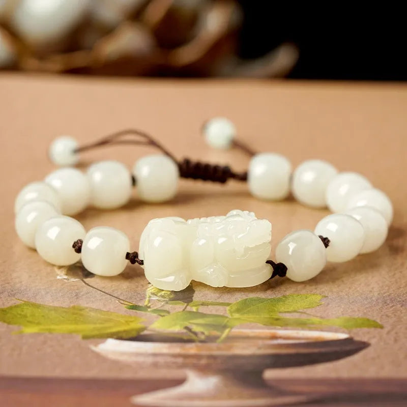 Hetian Jade bracelet with a black and red braided rope band and a central jade bead.