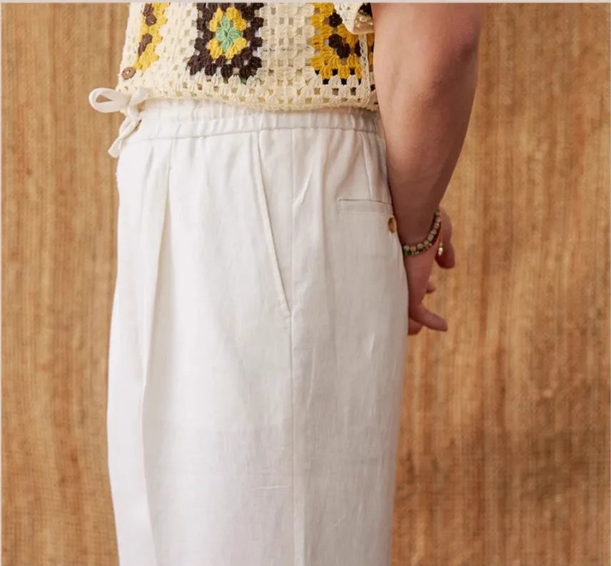Women's linen high-waist trousers with elasticated waistband in navy blue, white, and greige colours