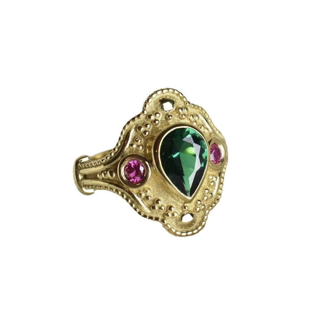 Geometric gold-coloured women's ring with an electroplated finish on a grey background.