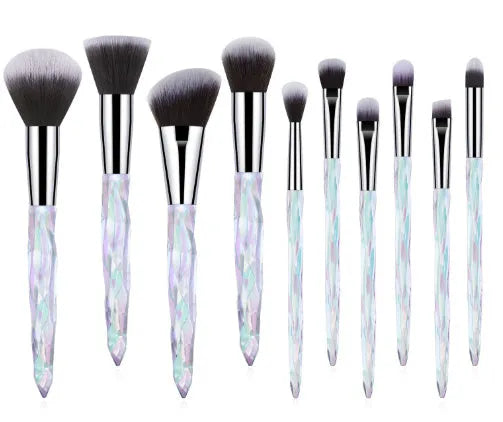 Ten clear crystal diamond shank foundation brushes with artificial fibre heads, shown in a set.