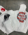 Black loose hooded cardigan sweatshirt with white skull and rhinestone print, long sleeves.