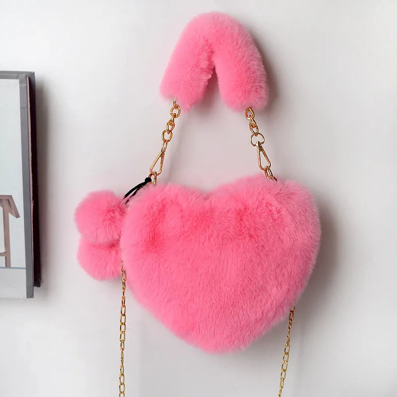 A soft plush heart-shaped women's handbag with a zipper and a detachable shoulder strap in a choice of 14 colours.