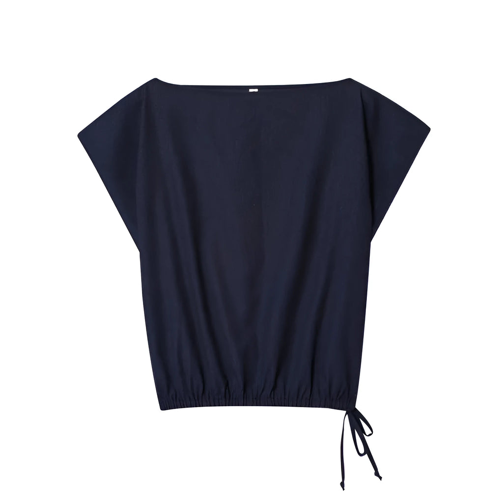 Women's linen blend co-ord set showing off-neck top with flounced sleeves and wide leg trousers.