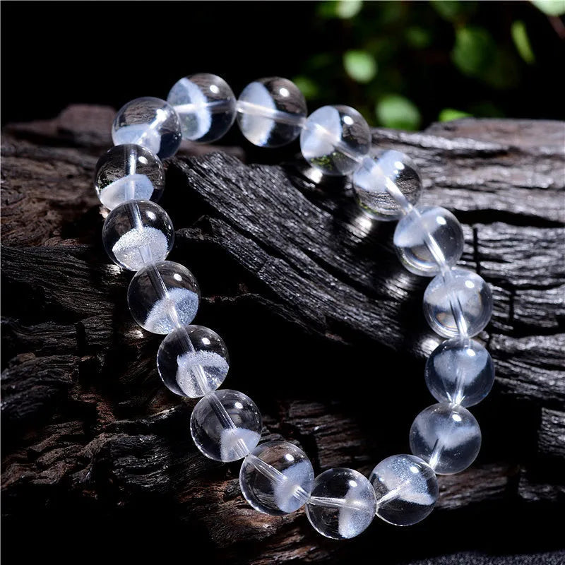 White crystal pyramid bracelet with natural ghost charm and Ruyi symbol detail on wrist