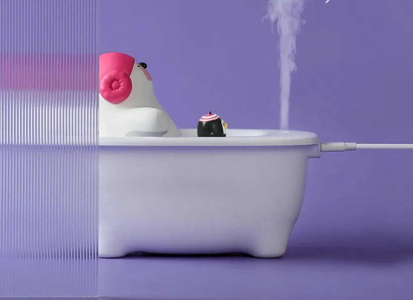 White polar bear-shaped USB air humidifier with water tank on a desk.