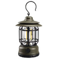 Dark green portable camping lantern with super bright LEDs, shown with a dry battery for scale.