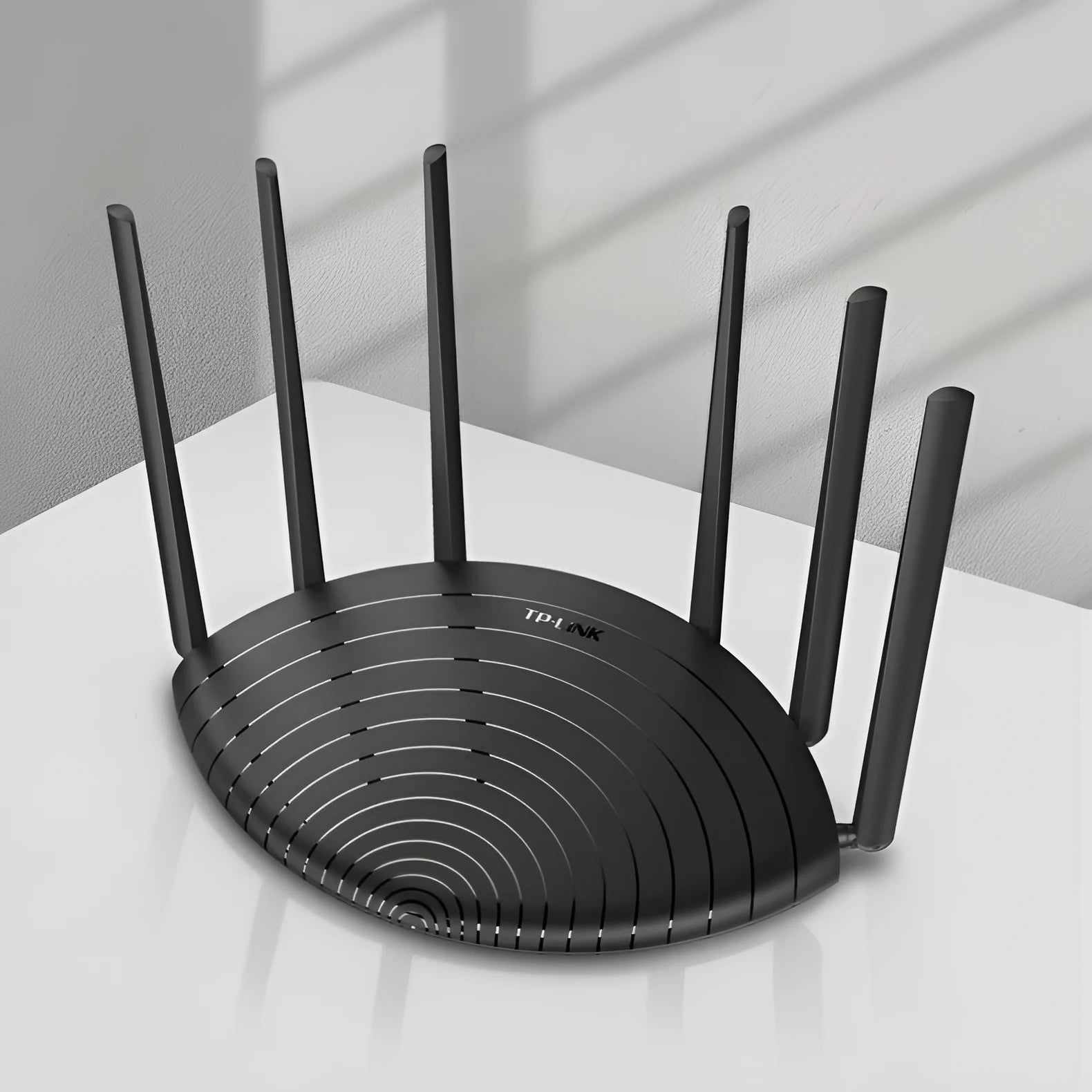 TL-WDR7661 AC1900 Gigabit wireless router with compact black design on a desk