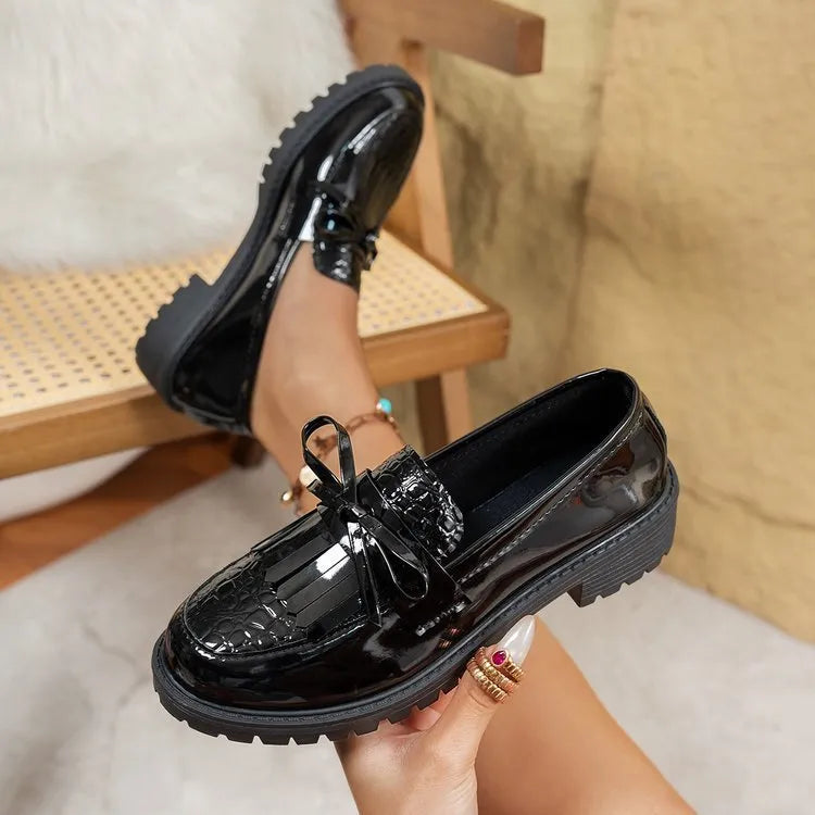 Women's brown and black bow-detailed flat loafers made from artificial PU, shown from the side.
