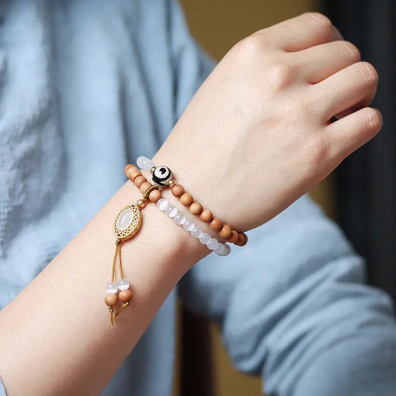 Mixed material bracelet with sandalwood double ring and opal Tibetan beads.