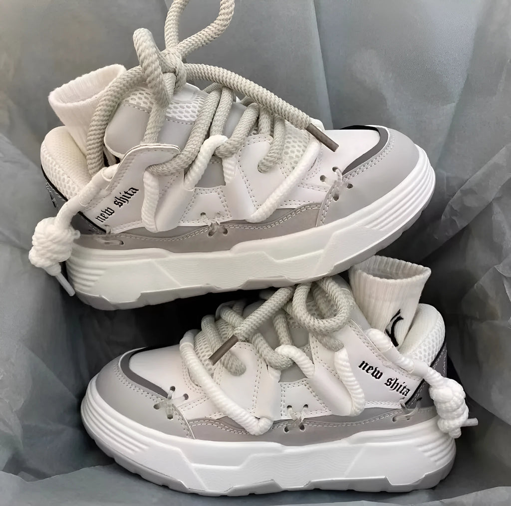 Women's thick bottom grey retro clunky sneakers with high heel on a white background.