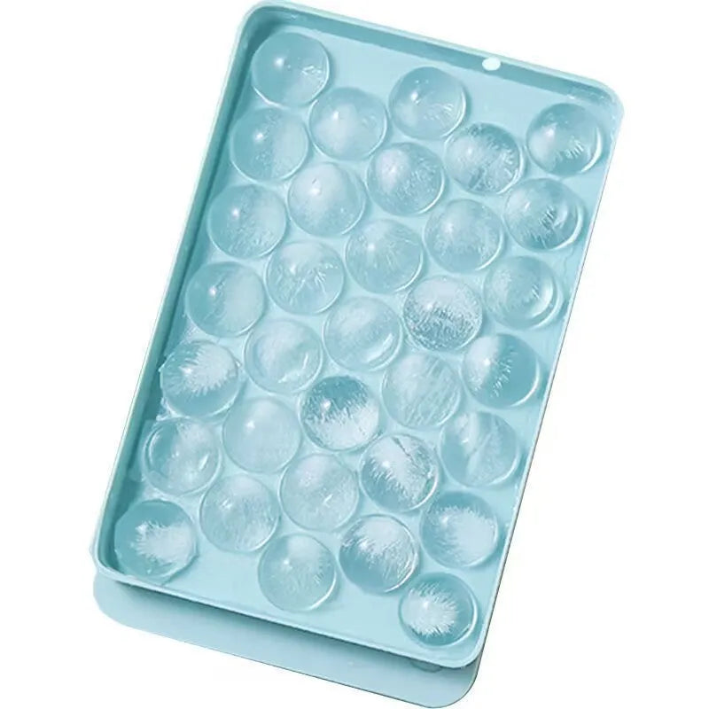 Blue silicone ice cube tray with lid showing 33 round compartments for homemade ice