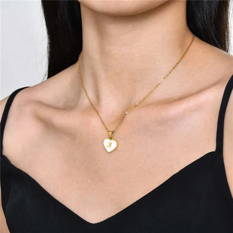 Gold plated heart-shaped necklace with white shell pendant on adjustable stainless steel chain