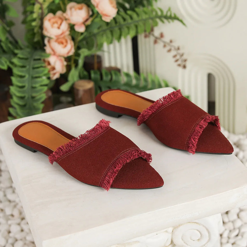 Women's denim flat slippers with tassel detail in multiple colour options showing leather lining and PVC sole