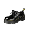 Women's black leather shoes with thick soles, ribbon cross-straps, and lace closure