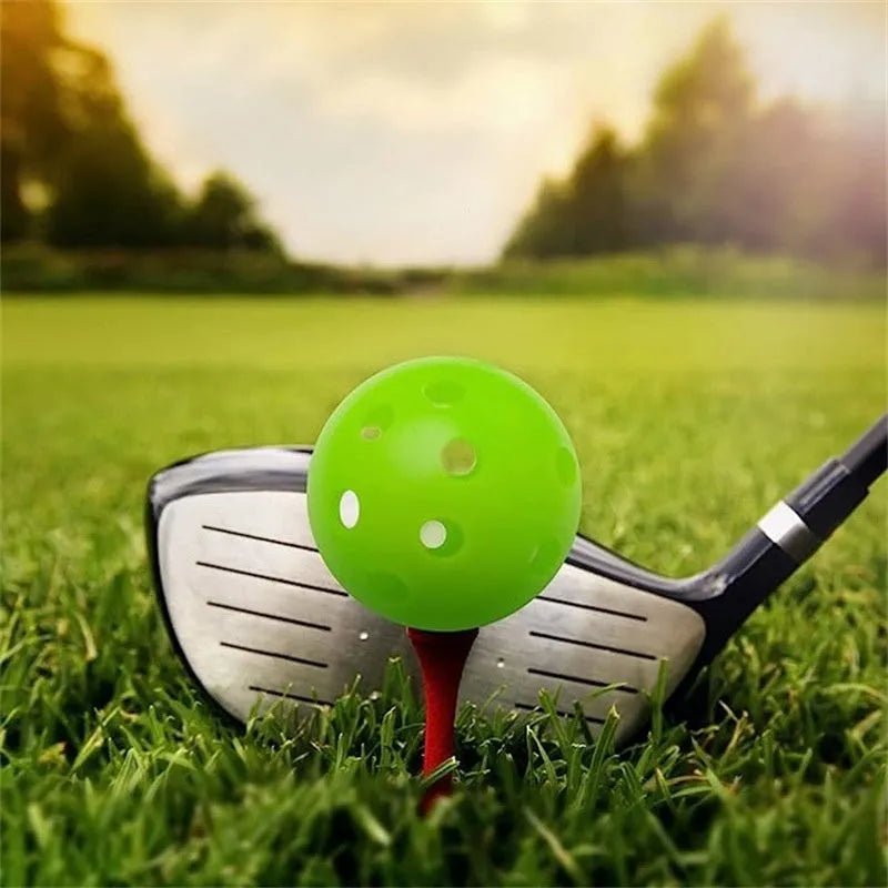 Six multi-colour 42mm golf practice balls in red, orange, blue, green, white, and yellow in a net.