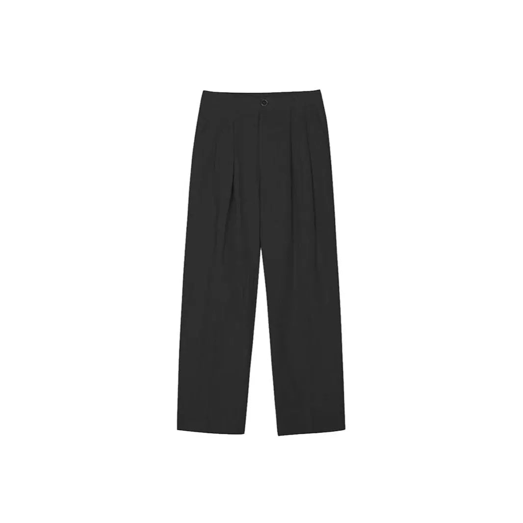 Man wearing apricot coloured loose wide-leg cotton linen trousers with a pencil leg opening.